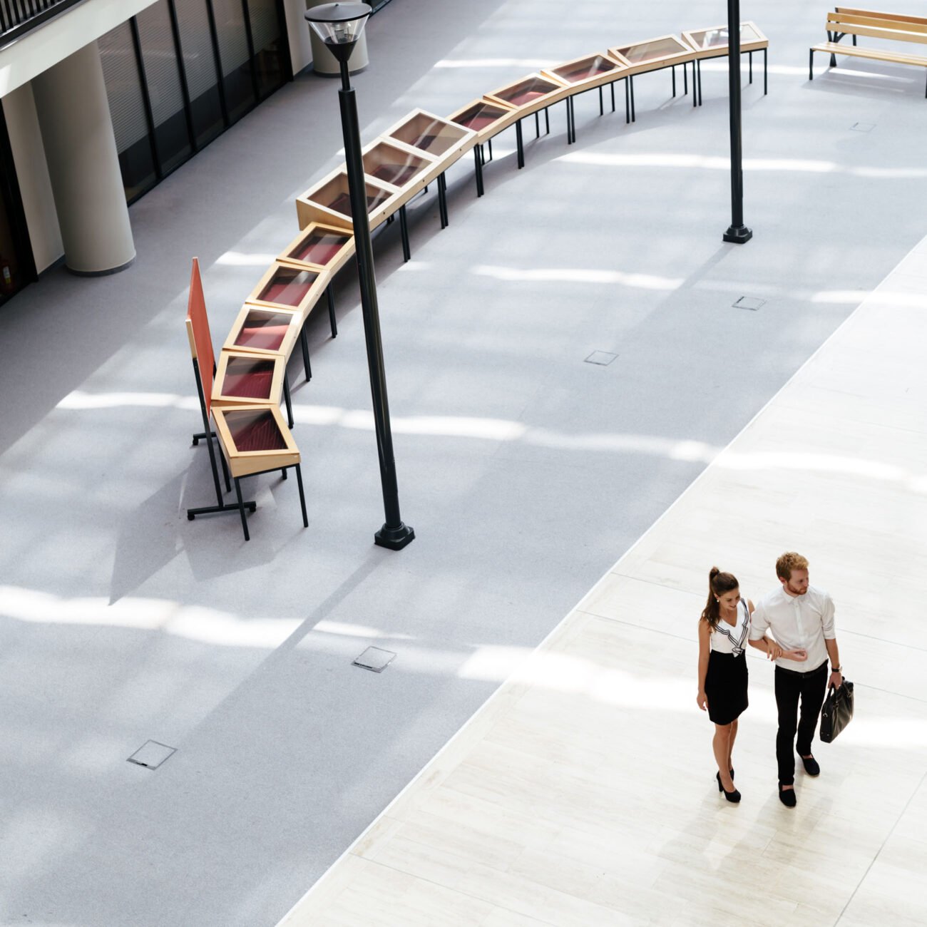 Young business couple walking together. Top view